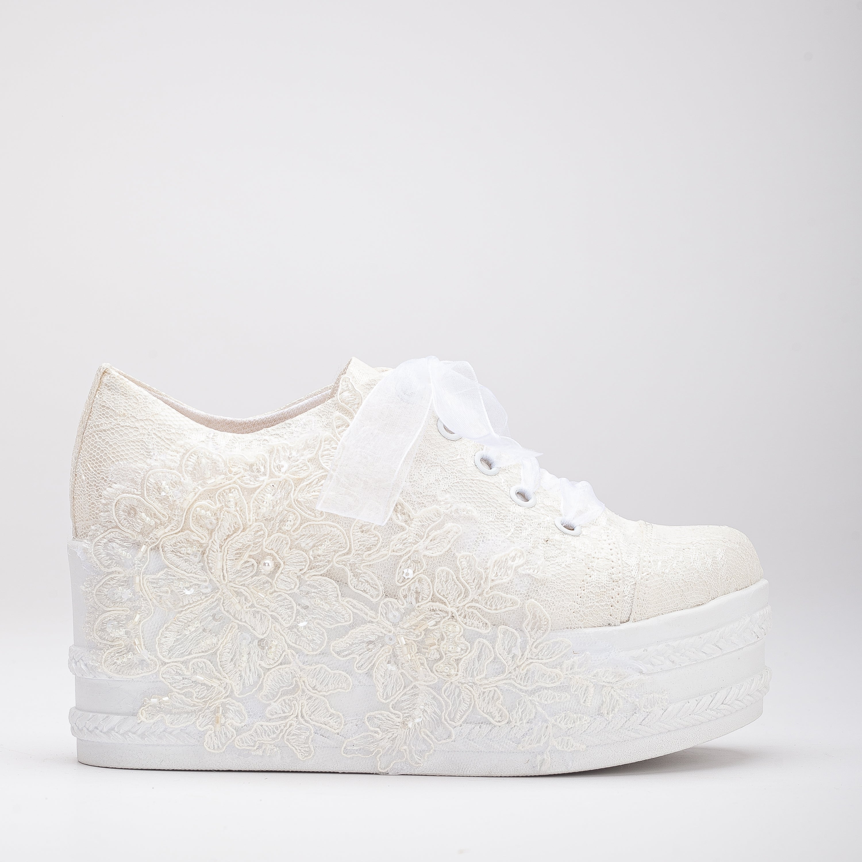 White wedding sneakers, Bridal sneakers in white, Wedding tennis shoes in white, White bridal trainers, White lace-up wedding sneakers, White canvas bridal sneakers, White platform wedding sneakers, White embellished wedding sneakers, White high-top wedding sneakers, White slip-on bridal sneakers.