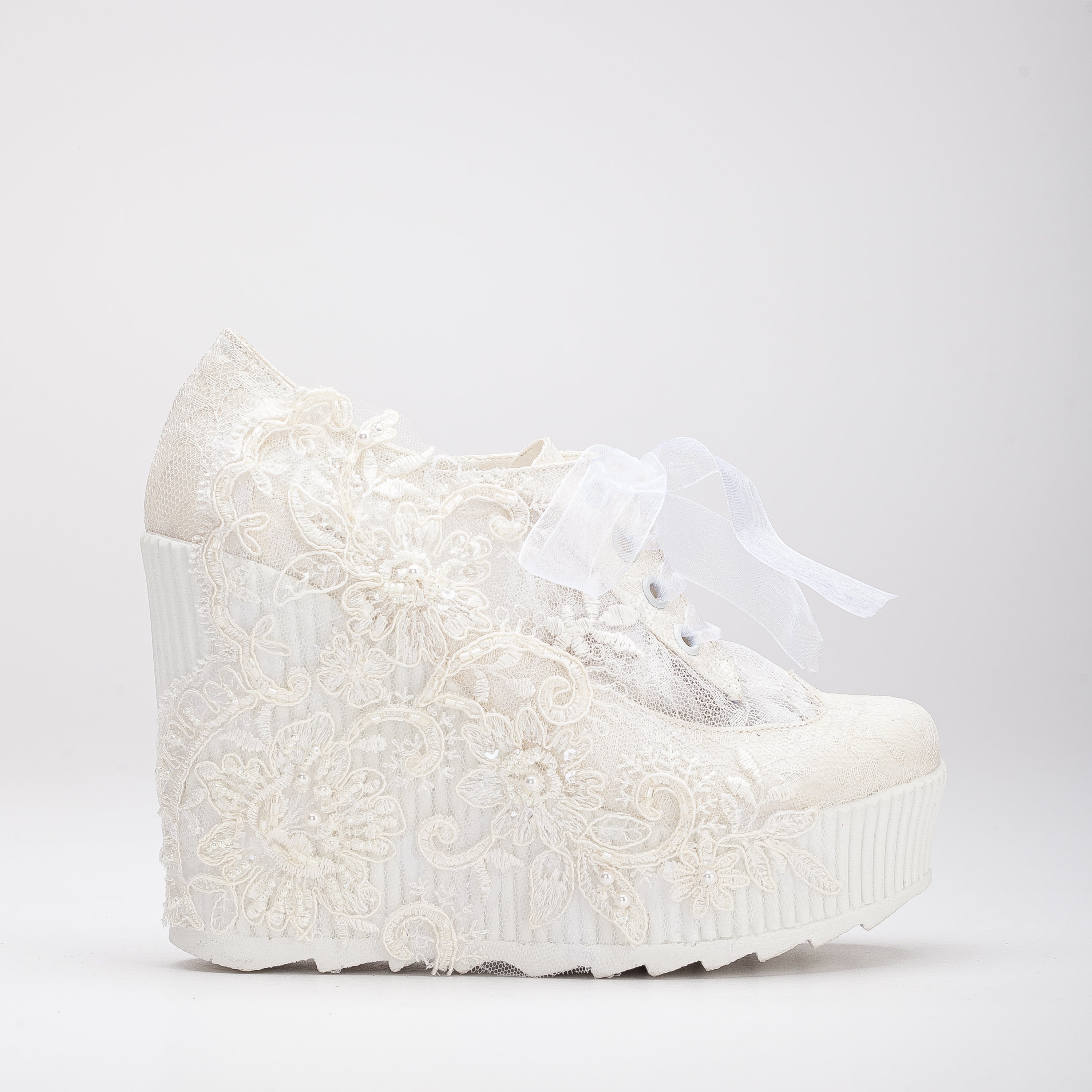 White wedding sneakers, Bridal sneakers in white, Wedding tennis shoes in white, White bridal trainers, White lace-up wedding sneakers, White canvas bridal sneakers, White platform wedding sneakers, White embellished wedding sneakers, White high-top wedding sneakers, White slip-on bridal sneakers.