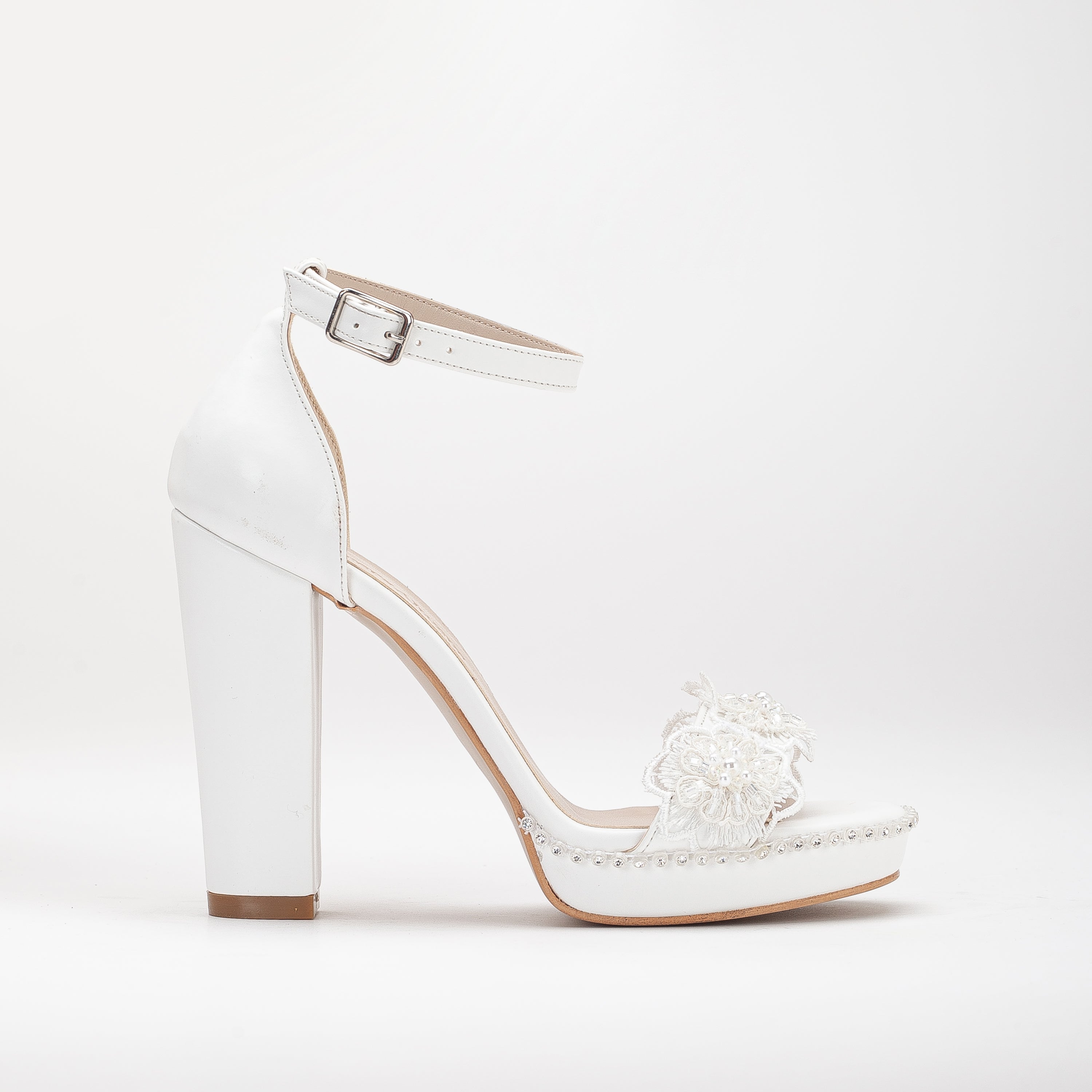 White platform bridal heels, high platform wedding shoes, elegant white bridal heels, tall platform bridal sandals, ivory platform wedding pumps, lace-up platform bridal heels, sparkling white platform shoes, peep-toe platform wedding heels, strappy platform bridal sandals, embellished platform bridal pumps.